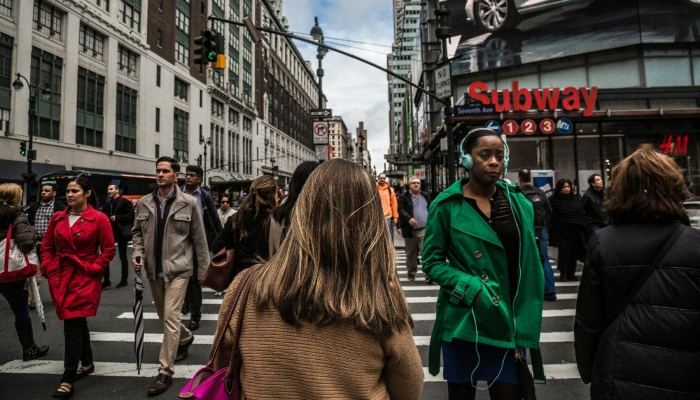 This representational image shows people walking on a road in New York City, US. — Unsplash