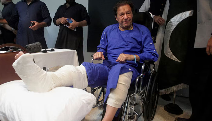PTI founder Imran Khan sits in a wheelchair after he was wounded following a shooting incident on a long march in Wazirabad, at the Shaukat Khanum Memorial Cancer Hospital & Research Centre in Lahore, November 4, 2022. — Reuters