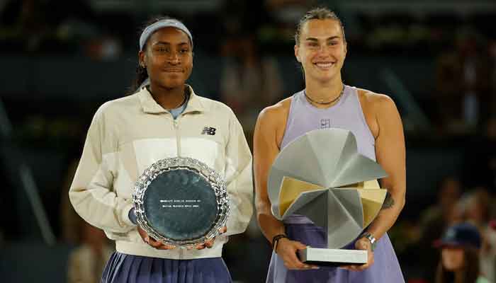Aryna Sabalenka and Coco Gauff of the US pose with the winners and runners up trophies after the womens singles final. — Reuters