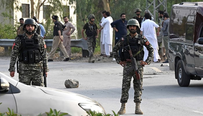 Pkistani security personnel gather at the site after the bomb blast in Hayatabad area of Peshawar on July 18, 2023. — AFP