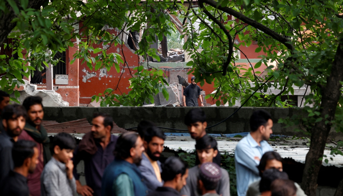 People gather next to a damaged portion of Bilal Mosque after it was hit by an Indian strike in Muzaffarabad, the capital of Azad Jammu and Kashmir, May 7, 2025. — Reuters