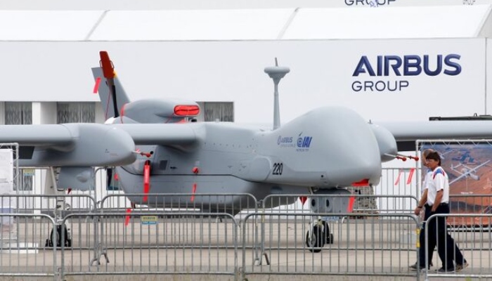 Visitors walk past a surveillance unmanned air vehicle (UAV) Heron TP by IAI and Airbus Defence at the ILA Berlin Air Show in Schoenefeld, south of Berlin, Germany, May 31, 2016. — Reuters
