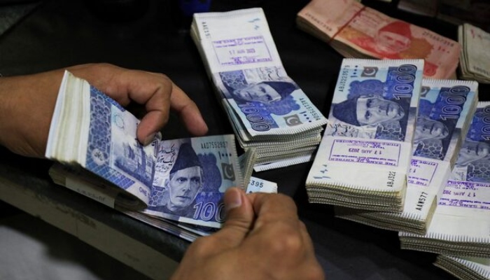 An employee counts Pakistani rupee notes at a bank in Peshawar, Pakistan August 22, 2023. — Reuters