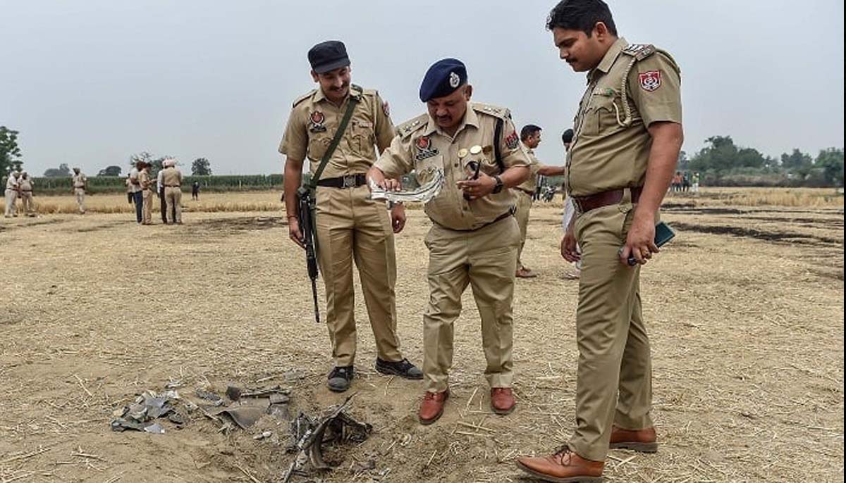 Indian police personnel inspect the debris of an unidentified projectile on the outskirts of Jalandhar on May 10, 2025, amid the ongoing conflict between Pakistan and India. — Reuters