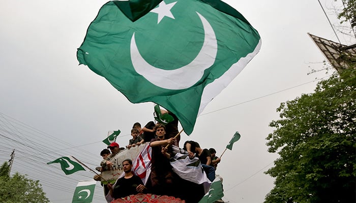 People wave flags as they rally in support of Pakistan Army, day after the ceasefire announcement between Pakistan and India in Lahore on May 11, 2025. — Reuters