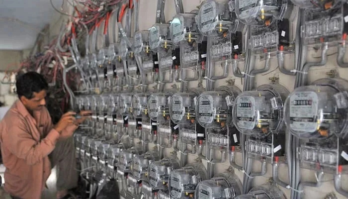 In this undated photo, a technician fixes new electricity meters at a residential building in Pakistan. — AFP/File