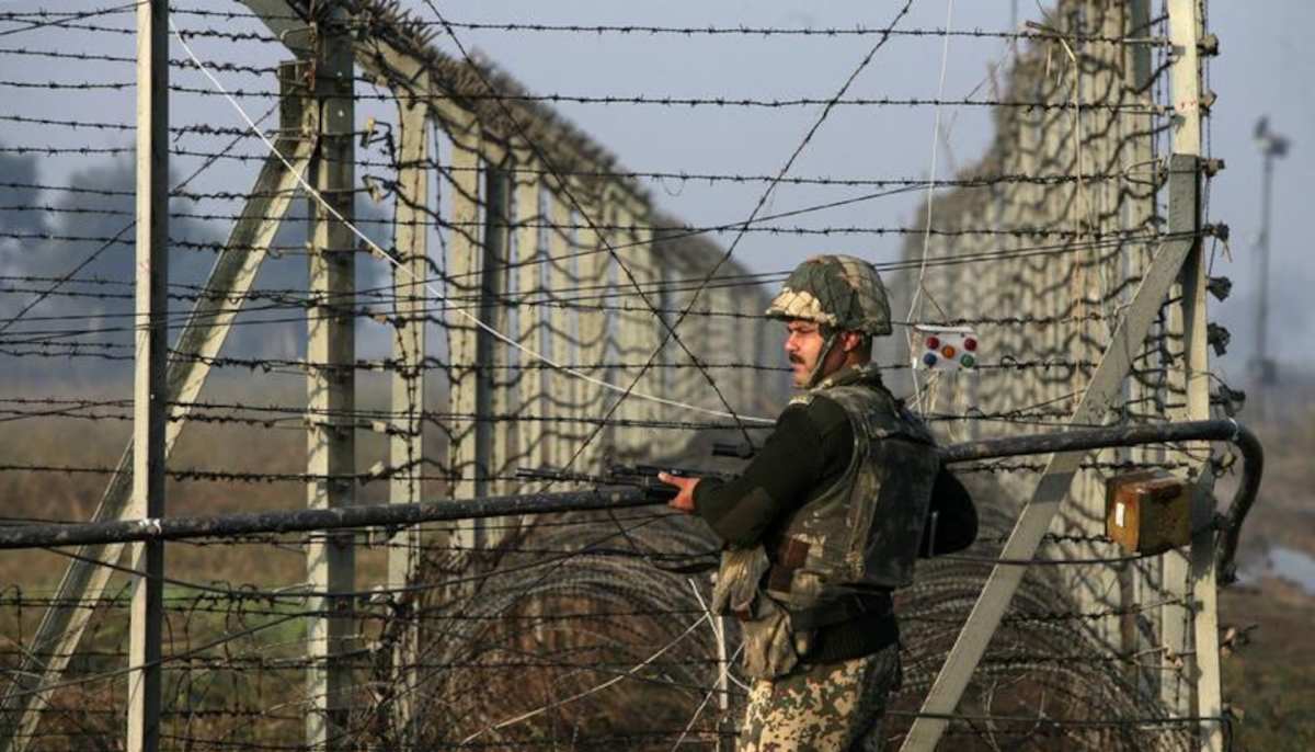 An Indian Border Security Force (BSF) soldier patrols near the fenced border with Pakistan in Suchetgarh, January 11, 2013. — Reuters