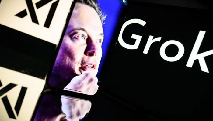 The image shows Elon Musk on the display screen of a mobile phone against the background where name of the AI chatbot developed by his startup xAI is written. — AFP