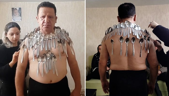 Abolfazl Saber Mokhtari, 54, breaks his own record for holding most spoons on his body — Guinness World Records