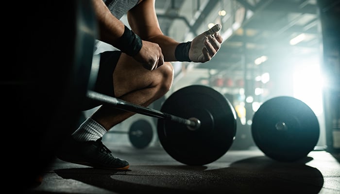 This file photo shows man preparing to lift barbell in health club. — Freepik
