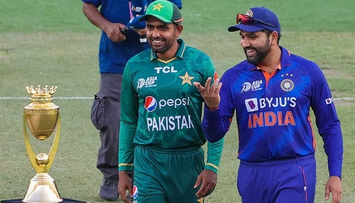 Pakistani cricketer Babar Azam (left) and Indian cricketer Rohit Sharma can be seen with the Asia Cup trophy during a match day. — AFP/File