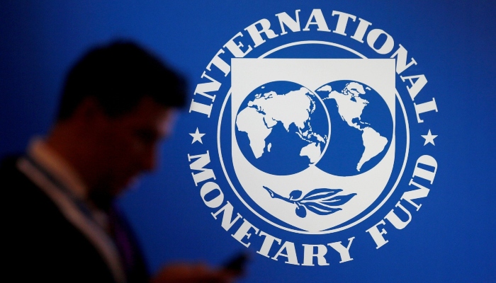 A participant stands near a logo of IMF at the International Monetary Fund - World Bank Annual Meeting 2018 in Nusa Dua, Bali, Indonesia, October 12, 2018. — Reuters
