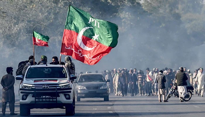 Supporters of jailed PTI founding chairman Imran Khan march towards Islamabad after clearing shipping containers placed by authorities during a demonstration demanding former prime ministers release, in Punjabs Hasan Abdal on November 25, 2024. — AFP