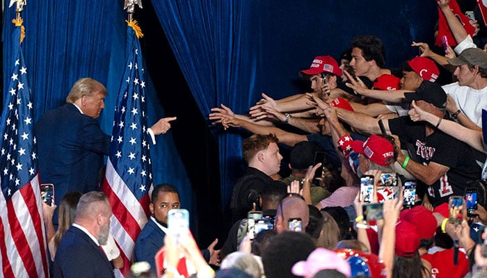Donald Trump gestures at supporters as he exits the stage at the end of a campaign rally at Mullet Arena. — AFP/File