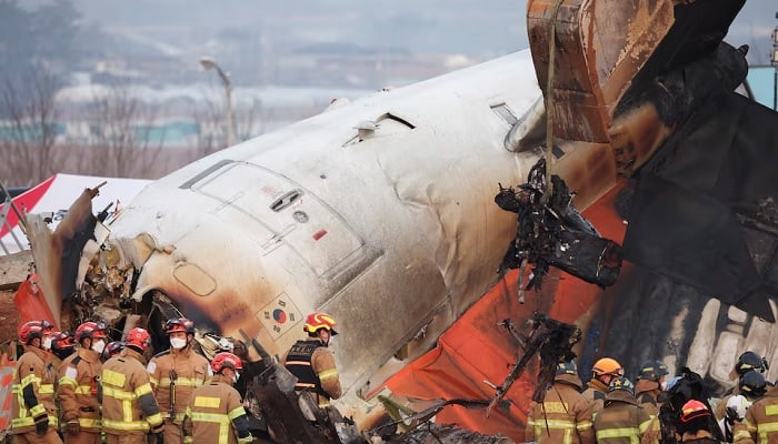 An excavator is used to lift burnt chairs from the wreckage of an aircraft that crashed after it went off the runway at Muan International Airport, in Muan, South Korea, December 29, 2024. — Reuters