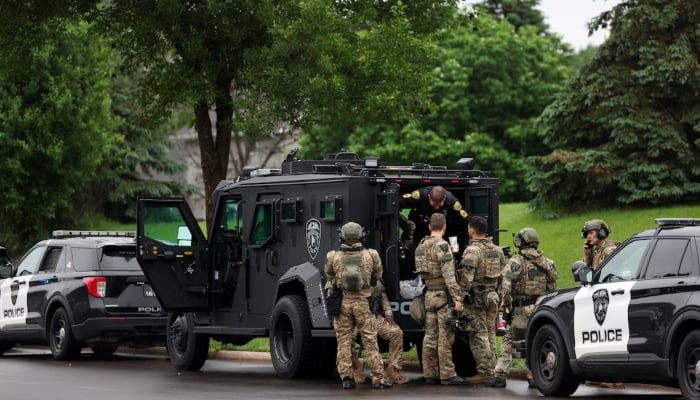 Officers are posted in a staging area after what police said was a targeted shooting in the area around Edinburgh Golf Course in the Minneapolis suburb of Brooklyn Park, Minnesota, US June 14, 2025. — Reuters