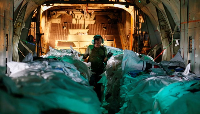 This representational image shows a worker preparing to release food aid from a cargo plane within Nasir town airspace, ravaged by fighting between local militiamen and the army, in an operation run by Fogbow, a US company organising the airdrops with funding from the South Sudanese government, in Nasir County of Upper Nile State, South Sudan June 10, 2025. — Reuters