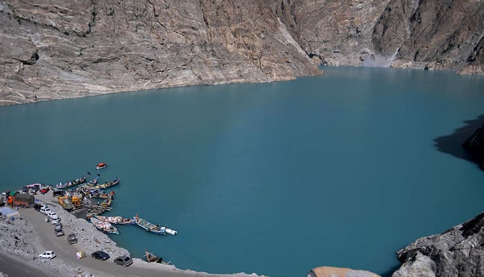 Pakistani residents board boats used to cross Attabad Lake, which was formed following a landslide in January 2010, in Pakistans Gojal Valley. — AFP