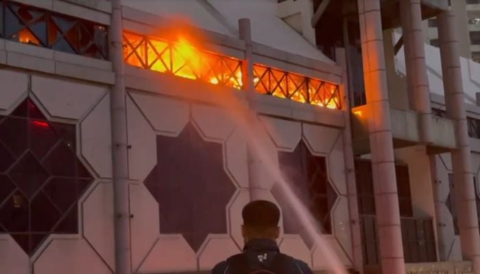A fire can be seen at a shopping mall on Rashid Minhas Road in Karachi, June 18, 2025. — Screengrab via Geo News