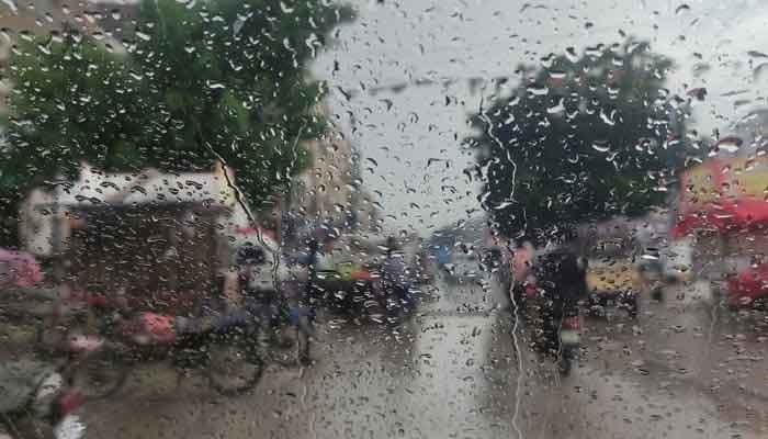 The image shows raindrops on a car window in Karachi. — Reuters/File