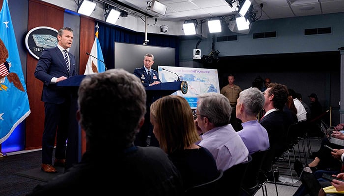 US Defence Secretary Pete Hegseth (L), accompanied by Chairman of the Joint Chiefs of Staff Air Force Gen Dan Caine (R), speaks during a news conference at the Pentagon on June 22, 2025 in Arlington, Virginia. — AFP