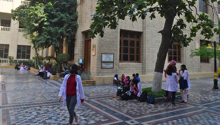 Students gather at a yard of the Dow University of Health Sciences in Karachi on January 13, 2022. — AFP