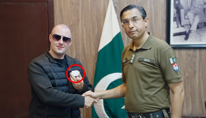 British social media influencer Miles Routledge, aka Lord Miles, shakes hand with a Jhelum Police DPO in this undated image. — X/@real_lord_miles