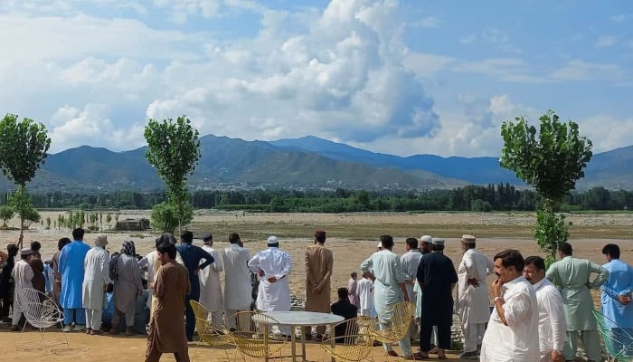 Residents gather, after tourists, who were on a picnic, were swept away by overflowing floodwaters in the Swat River, in Swat Valley on June 27, 2025. — Reuters