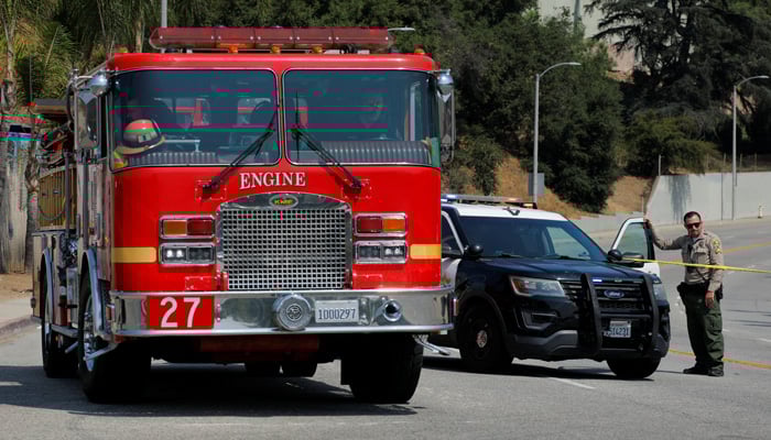 A fire truck leaves a sealed-off area as a police officer blocks the road to the Los Angeles County Sheriffs Departments Biscailuz Center Academy Training facility, where fellow officers were killed following an explosion, in East Los Angeles, California, US on July 18, 2025. — Reuters