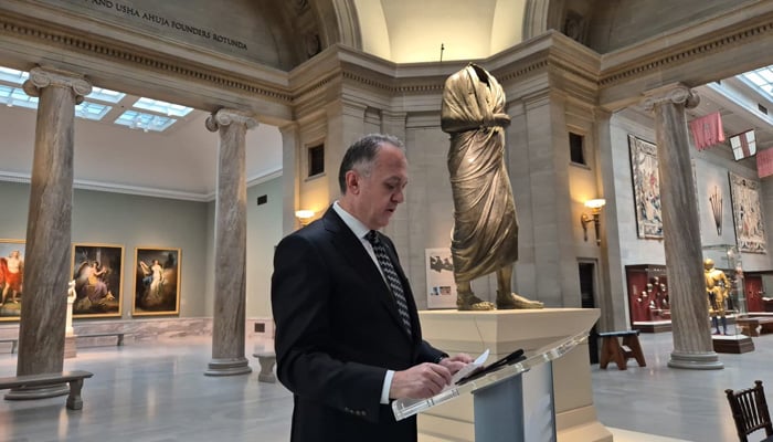 Turkiyes Deputy Culture Minister Gökhan Yazgı stands next to an ancient statue that depicts Roman emperor and philosopher Marcus Aurelius. — X/@yazgi_gokhan