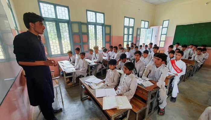 Students attend a class as a teacher delivers a lecture in a school in Khyber Pakhtunkhwa. — Reuters/File