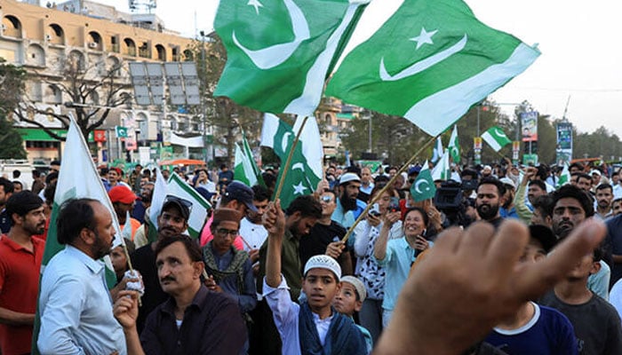 People wave Pakistani flags in celebration after the ceasefire announcement between Pakistan and India in Islamabad on May 10, 2025. — Reuters