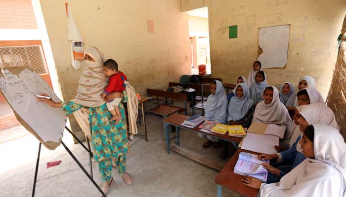 Teacher Nazia Hussain (L) and her class at a government school in southwestern Punjab province. — AFP/File