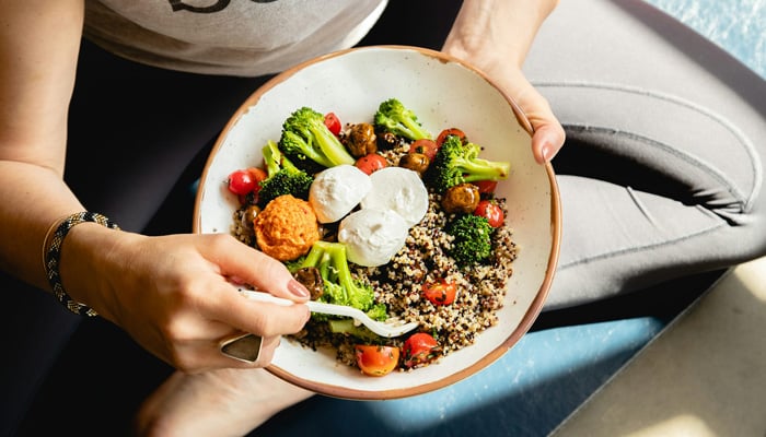 This representational image shows a person holding a salad. — Unsplash