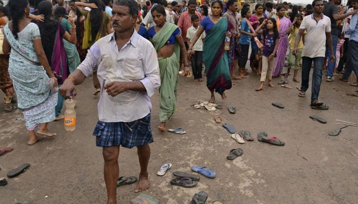 Devotees walk at the site of a stampede on the banks of river Godavari, to attend the Maha Pushkaralu, a Hindu festival, at Rajahmundry in Andhra Pradesh, India, July 14, 2015. — Reuters