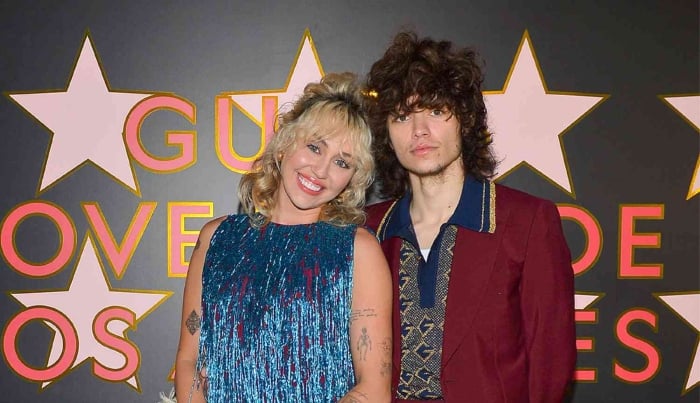 Photo:  Miley Cyrus leaning on beau Maxx Marondo