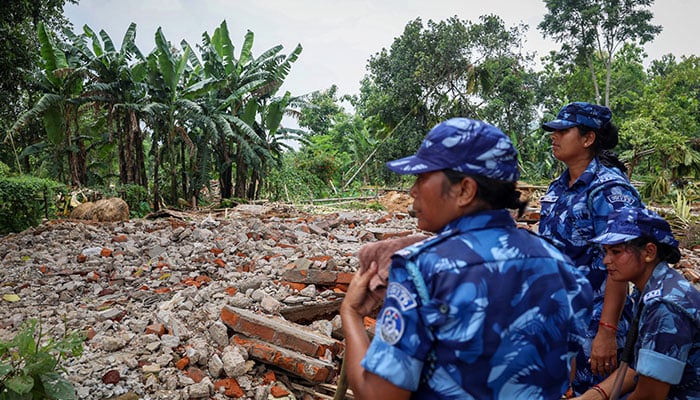 Security officials stand guard at a demolition site in Goalpara district in the northeastern state of Assam, India, July 18, 2025. — Reuters