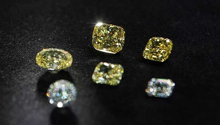 A view shows polished colorless and yellow diamonds produced at Diamonds of ALROSA factory in Moscow, Russia April 30, 2021. — Reuters