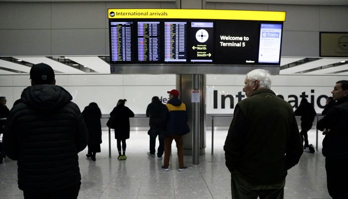 People wait in the arrivals hall at Terminal 5 of Heathrow Airport in London, Britain, December 5, 2023. — Reuters
