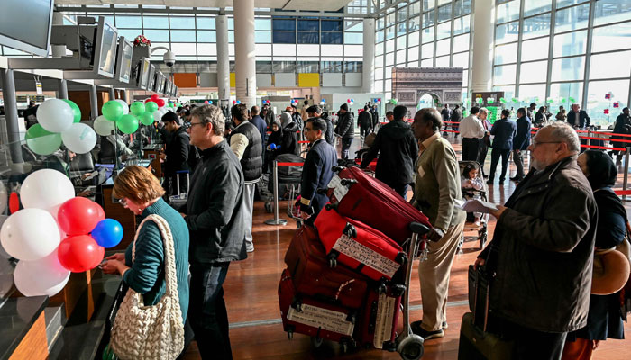 Passengers wait at the immigration counter before boarding at the Islamabad International Airport on January 10, 2025. — AFP