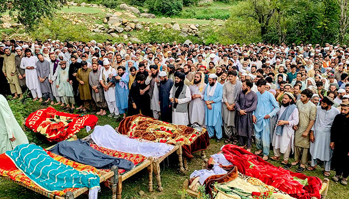 Mourners and locals offer funeral prayers for victims who died in incidents related to flash floods and monsoon rains in Salarzai Tehsil of Bajaur district on August 15, 2025. — AFP