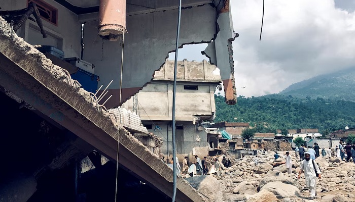 Men walk past damaged houses following heavy rain and floods in Buner district in Khyber Pakhtunkhwa province, August 16, 2025.— Reuters