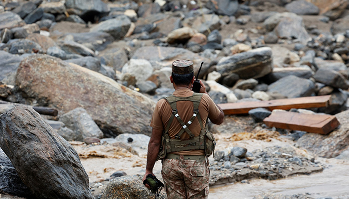 An army soldier monitors rain water flowing from mountains crossing a damaged area, following a storm that caused heavy rains and flooding in Bayshonai Kalay, in Buner district, Khyber Pakhtunkhwa, August 18, 2025. — Reuters