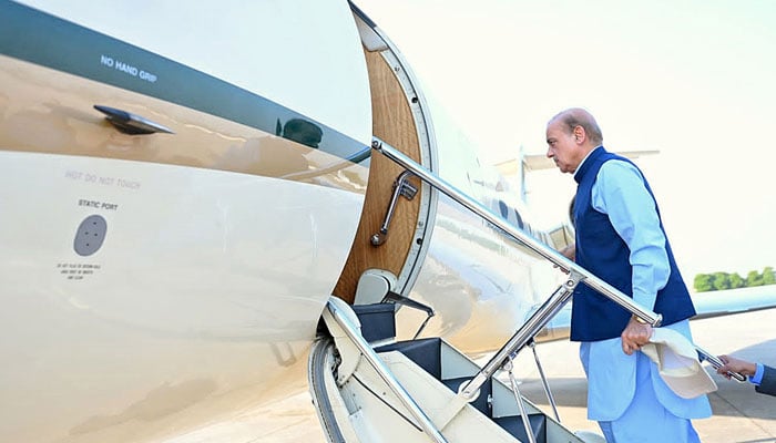 Prime Minister Shehbaz Sharif boarding a plane in this undated image. — APP/File