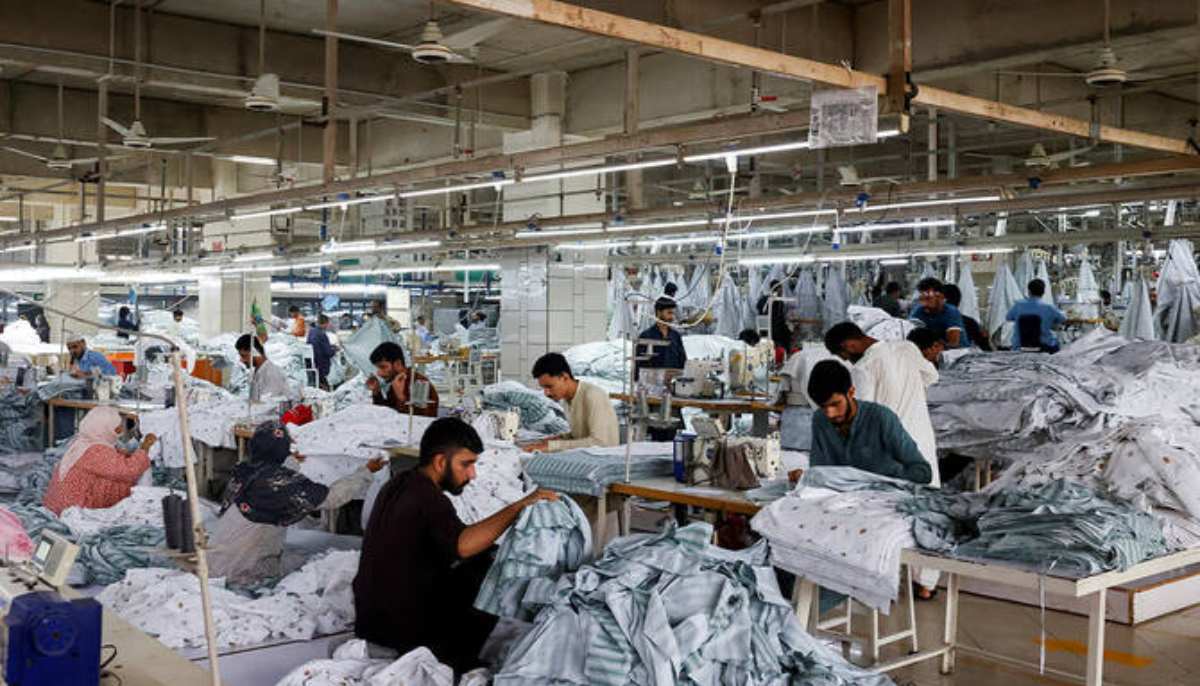Workers sew, while others sort out fabric sheets, at a stitching unit of the textiles manufacturer of the Liberty Mills Limited, in Karachi on August 2, 2025. — Reuters