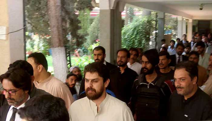 Policemen escort tribal chief Sherbaz Satakzai, accused of ordering the deaths of a couple in a so-called honour killing, at a local court in Quetta, July 21, 2025.