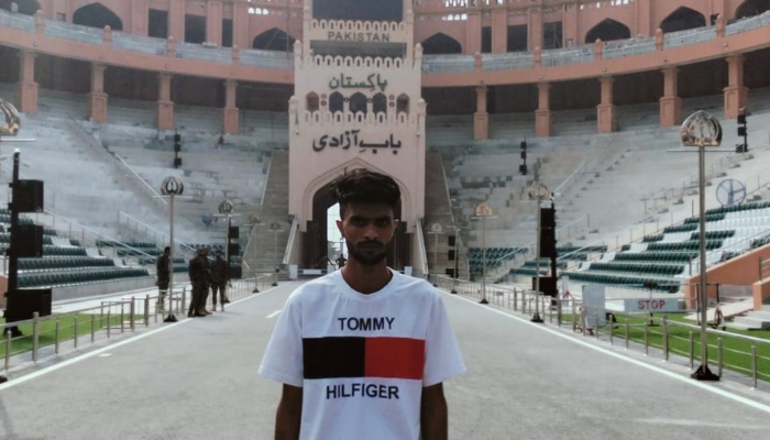 Raqib Bilal, who had been imprisoned in India, stands in front of Bab-e-Azadi in Lahore, after his repatriation, on September 29, 2025. — Photo via X/@PakinIndia