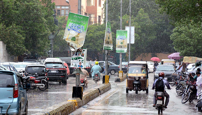 Commuters are passing through a road during the downpour of monsoon season, at Saddar area in Karachi on Tuesday, September 30, 2025. — PPI