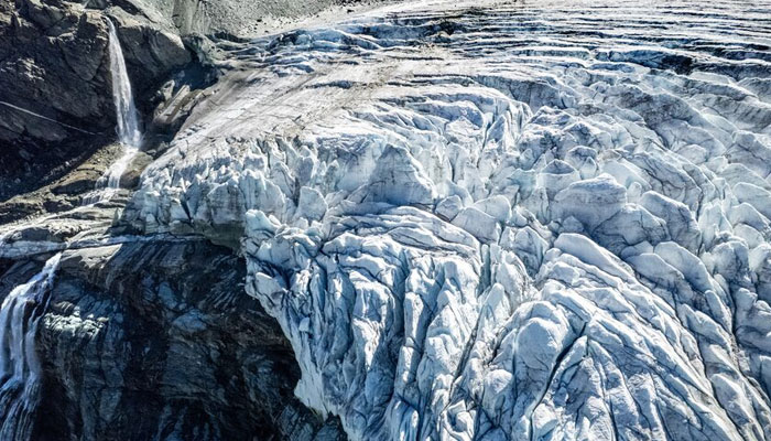 A drone view shows water from melting ice running down the side of the Turtmann glacier on a warm summer day, amid climate change, in Turtmann, Switzerland, September 3, 2025. — Reuters