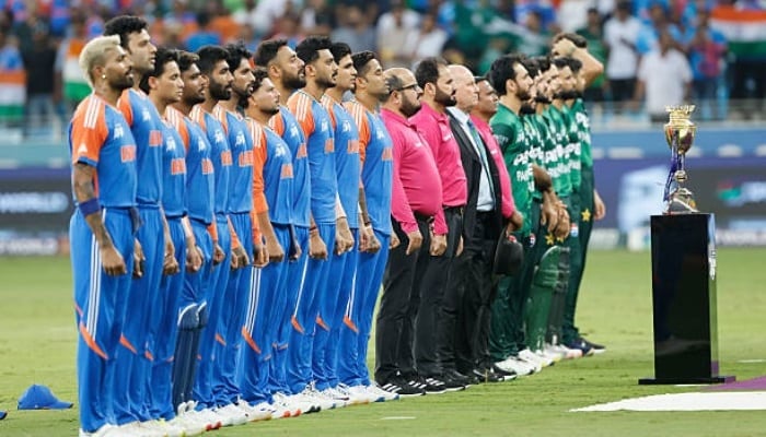 Pakistani and Indian players stand at the national anthem during the match at Dubai International Stadium on September 21, 2025, in Dubai, United Arab Emirates. — AFP